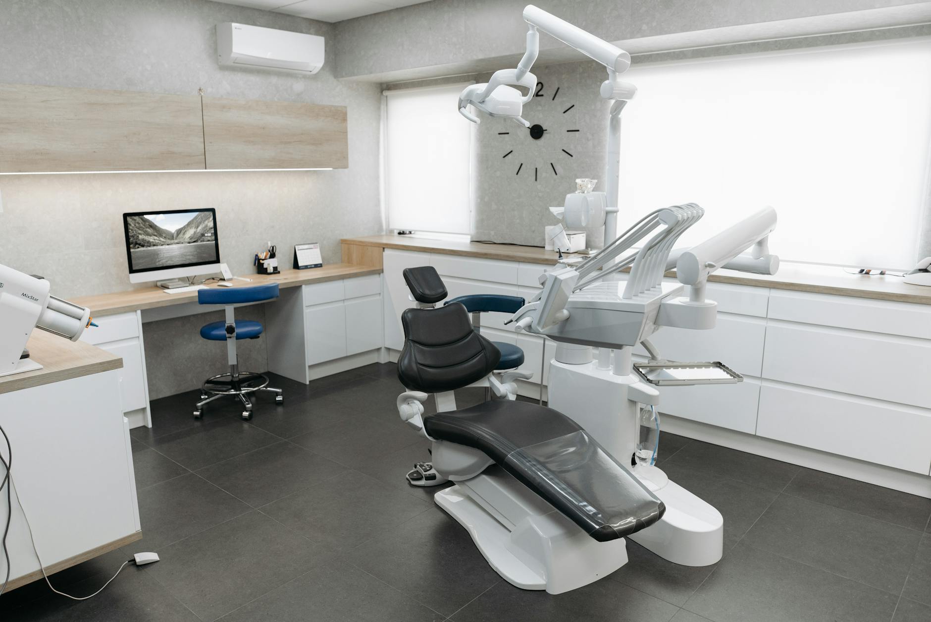 Modern dental clinic interior featuring a dental chair and equipment with a minimalist design